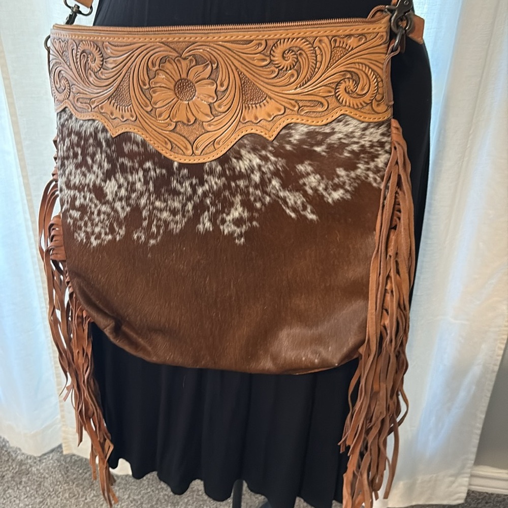 - Cowhide, tooled leather, dual carry
